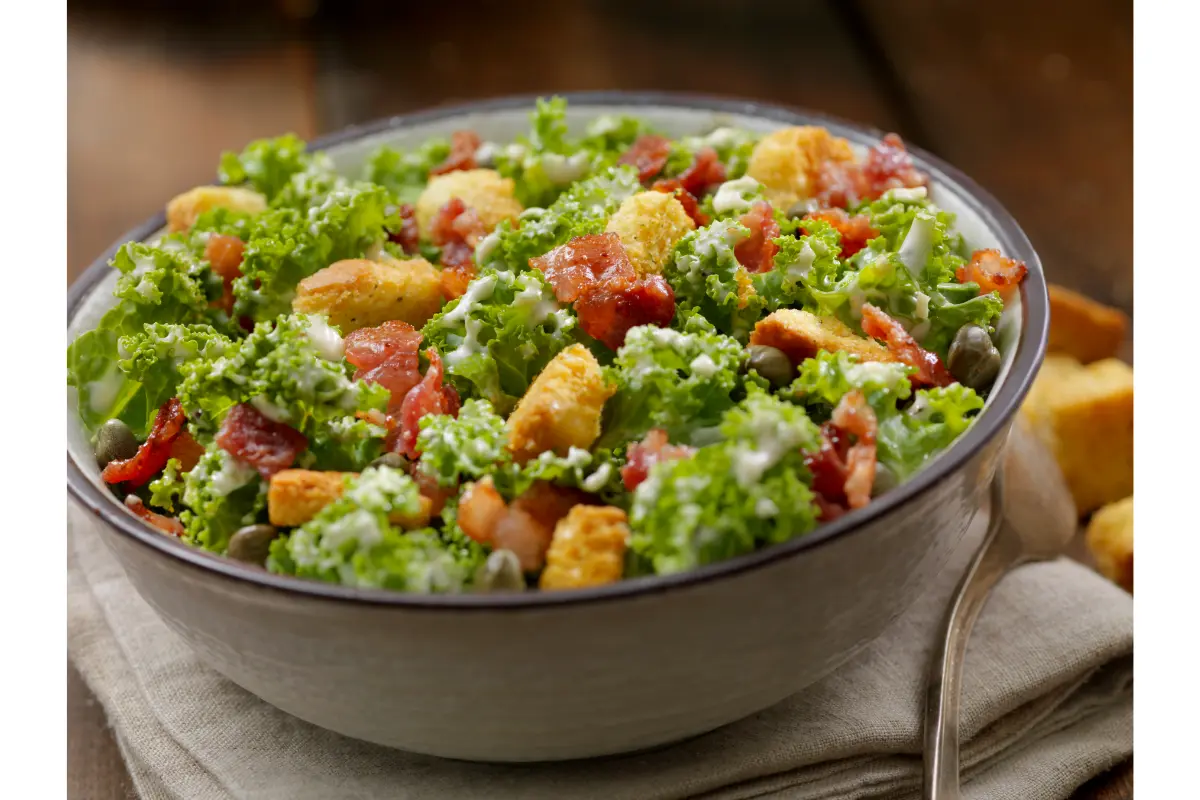 A chef expertly preparing a Caesar salad, highlighting culinary skill and precision."