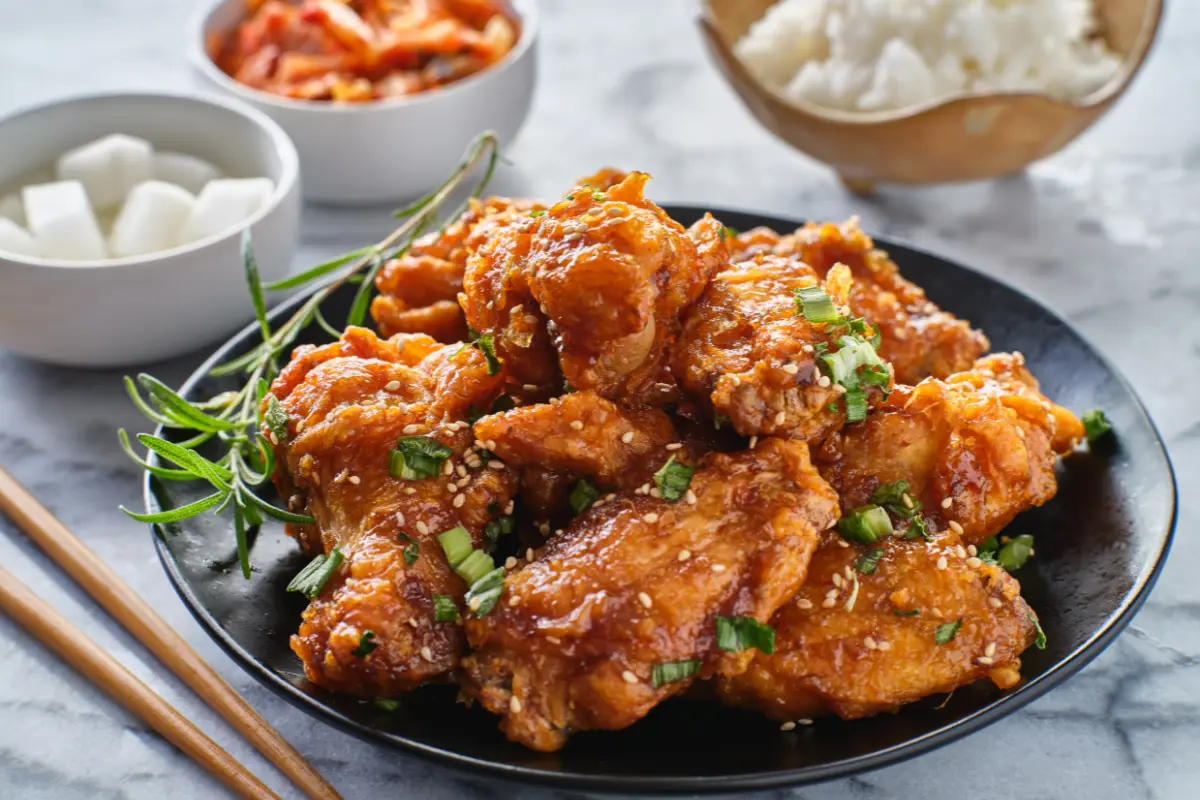 Fresh chicken wings, maple syrup, hot sauce, and cornstarch arranged for Crispy Maple Hot Wings recipe