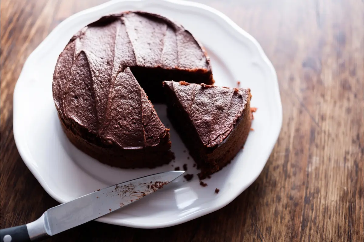 "Guests at a party being served slices of a delicious money cake, with a visible pull-out cash feature