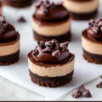 Mini chocolate cheesecake bites with ganache and berries